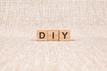 DIY word written on wood blocks. text on brown backgrond for your desing, concept