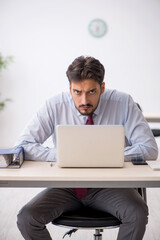 Young male employee working in the office