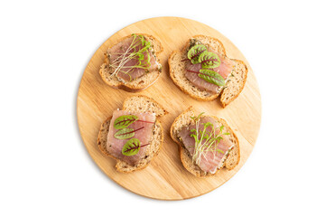 Bread sandwiches with jerky salted meat, sorrel and cilantro microgreen isolated on white. top view.