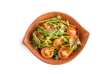 Vegetarian salad of tomatoes, marigold, microgreen isolated on white. Top view, close up.