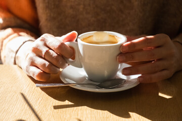 unrecognizable woman having a coffee in her free time