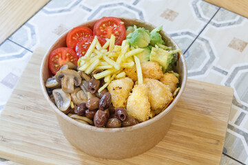 Vegeterian seafood bowl with smoked salmon, shrimp, avocado in take out paper container. Close up, copy space, top view, background.