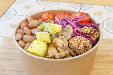 Vegeterian seafood bowl with smoked salmon, shrimp, avocado in take out paper container. Close up, copy space, top view, background.