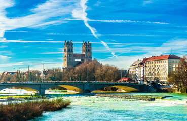 Fototapeta premium View on winter landscape by St. Maximilian church and Isar in Munich