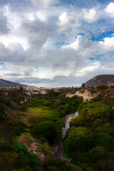 Landscape with a river, trees and clouds in Mitad del Mundo, Ecuador
