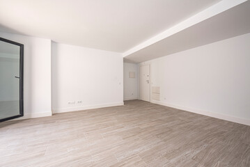 Empty living room with a large window on one side light stoneware flooring and white painted walls