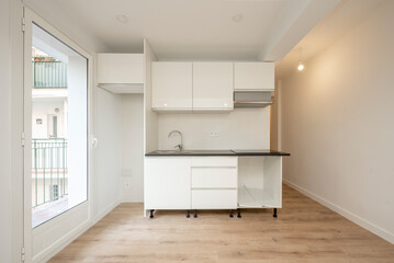 semi-furnished kitchen in apartment with glass door leading to a terrace