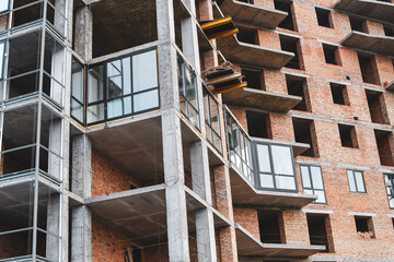 Detail of constructed monolithic building with the process of mounting windows.