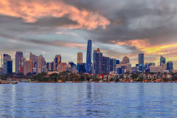 Sydney Harbour Australia at Sunset with the turquoise colours of the bay and high rise offices of the City in the background