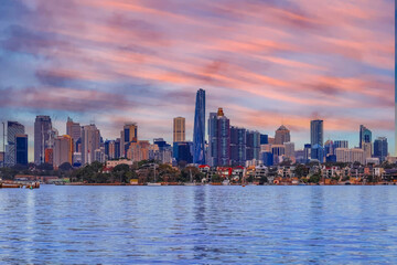 Sydney Harbour Australia at Sunset with the turquoise colours of the bay and high rise offices of the City in the background