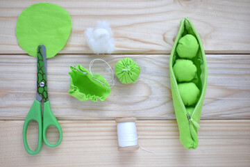 toy pea pod with peas made of fabric for the development of fine motor skills in children