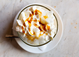 Traditional french dessert, ile flottante decorated with caramel and whipped cream