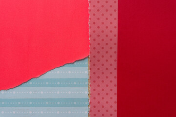 mostly red paper background with torn edges and some blue