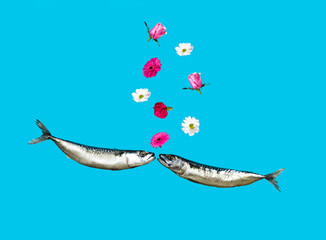Various flowers and two fish is kissing on pastel blue background. Creative minimal concept. Love is in the air. Valentines Day funny idea.