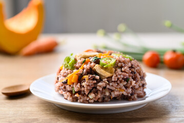 Fried purple rice with tofu, carrot, pumpkin and chili pepper. Healthy Asian vegan food