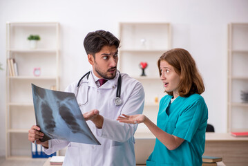 Young male doctor radiologist and female assistant working in th