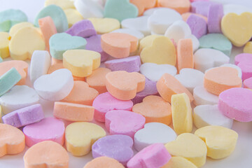 Conversation hearts on white background flat lay.