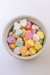 Conversation hearts on white background flat lay.