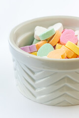 Conversation hearts on white background flat lay.