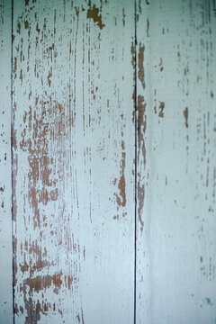 Rough and faded paint on wooden wall. Straight on.