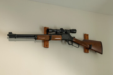 Rifle with scope on wall