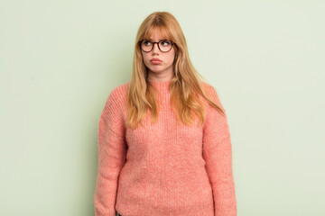 redhead pretty woman feeling sad, upset or angry and looking to the side with a negative attitude,...
