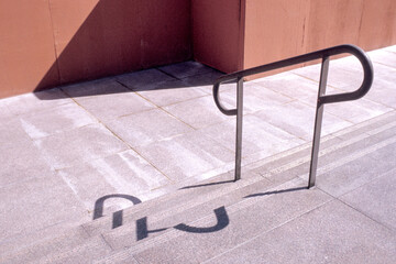 Hand railing with shadow on concrete steps