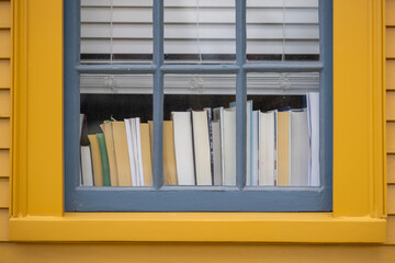 Books on window sill through closed widow