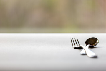 closeup of knife and fork on table top