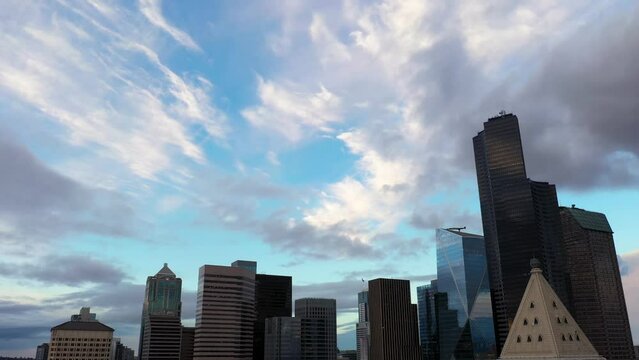 Aerial rising above Smith Tower to show the beautiful blue sky filled with wispy clouds.