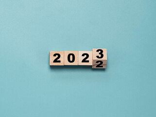 Wooden block cube flipping between 2022 to 2023 for change and preparation merry Christmas and...