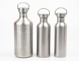 Steel flasks for water and drinks on a white background. Survival hiking gear