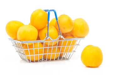 Ripe apricots in a grocery basket from a supermarket on a white background
