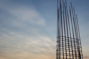 Steel reinforce in concrete column.Steel grid on the construction site.Reinforcement of concrete work. Using steel wire for securing steel bars with wire rod for reinforcement of concrete at sunset