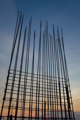 Steel reinforce in concrete column.Steel grid on the construction site.Reinforcement of concrete work. Using steel wire for securing steel bars with wire rod for reinforcement of concrete at sunset