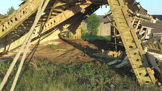 Koeru.Estonia-July 5.2021: Drone shot of an old soviet farm building. Nature taking over old soviet buildings that are slowly decaying. Camera slowly moving backwards.