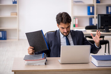 Young male employee working in the office