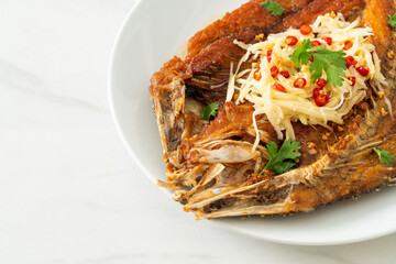 Fried Sea Bass Fish with Fish Sauce and Spicy Salad