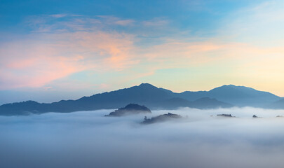 Sunrise over the mountain range with colorful sky and amazing landscape, Sea of mist in Tropicana rainforest south east Asia landscape. southern Thailand, outdoor and camping in the morning.
