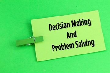 colored paper clamped with the words decision making and problem solving