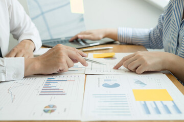 Two business leaders talk about charts, financial graphs showing results are analyzing and calculating planning strategies, business success building processes