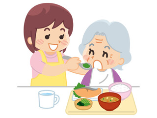高齢女性に食事介助を行う介護士　ヘルパー