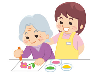 塗り絵を楽しむ高齢女性と介護士　ヘルパー