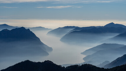 Great landscape at lake Iseo in winter season. Foggy and humidity in the air. Panorama from Monte Pora, Italian Alps, Italy