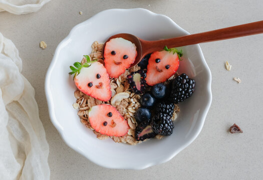 Healthy homemade breakfast snacks. Muesli Breakfast Bowl with Berries. Delicious wholesome breakfast meal with fresh fruits and nuts for your day's energy requirements.