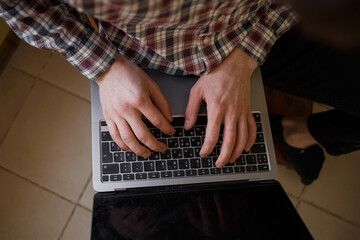 Fototapeta na wymiar Man typing on laptop keyboard, work and business concept