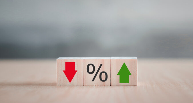 Interest rate financial and mortgage rates concept. Wooden cube block with icon percentage symbol and arrow up and down direction