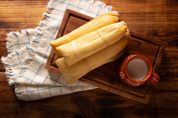 Obraz na płótnie Canvas Tamales. Prehispanic dish typical of Mexico and some Latin American countries. Corn dough wrapped in corn leaves. The tamales are steamed.