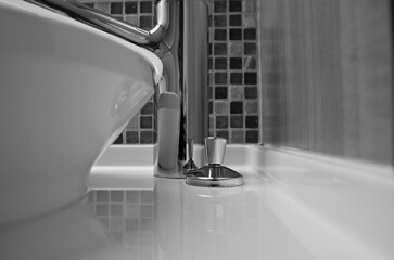 Modern design bathroom with sink, shower, towels and mirror and mosaic tiles in cabin or stateroom...