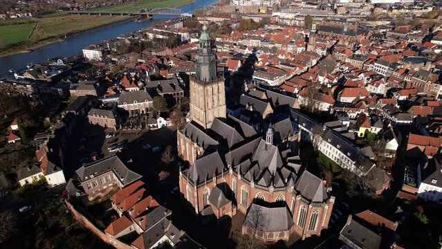 Walburgiskerk church in picturesque tower town of Zutphen in The Netherlands with river IJssel in  the background. Aerial view of Dutch medieval city.